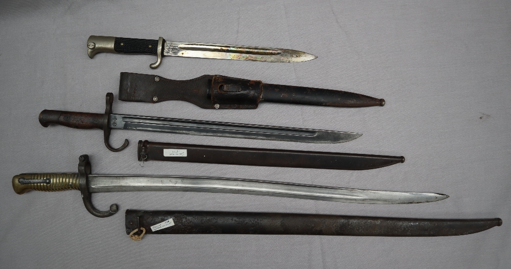 A French 1864 sabre bayonet and scabbard together with a Japanese Arisaka 1897 pattern bayonet and