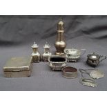 A George V silver sugar caster with a turned finial and domed top on a baluster column and