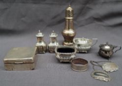 A George V silver sugar caster with a turned finial and domed top on a baluster column and