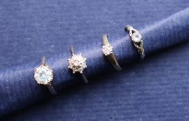 A diamond cluster ring set with nine round brilliant cut diamonds,