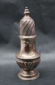 A large Victorian silver sugar caster with a turned finial and pierced dome top above a baluster