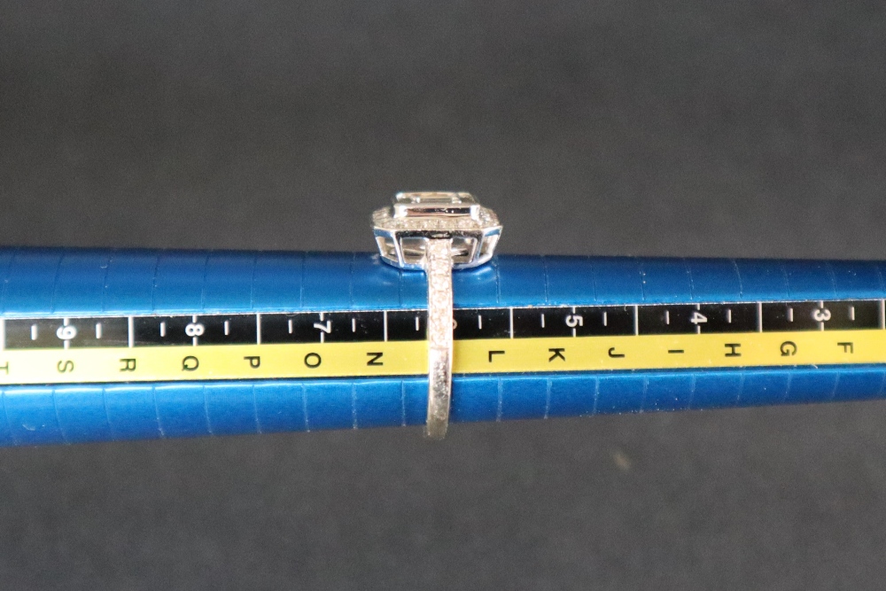 An 18ct white gold diamond cluster ring set with baguette and round brilliant cut diamonds to the - Image 7 of 7