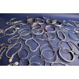 A collection of silver and white bracelets,