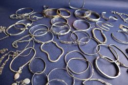 A collection of silver and white bracelets,