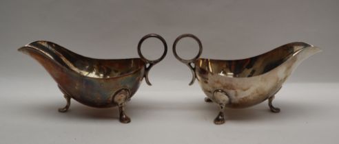 A pair of George VI silver sauce boats of usual form with ring handle and three legs with pointed