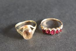 A five stone garnet ring, to a yellow metal setting and shank,