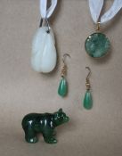 A 9ct gold mounted carved green jade panel, 23mm diameter together with a pair of jade earrings,
