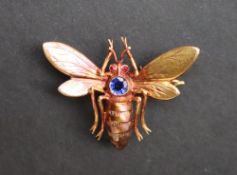 A yellow metal brooch in the form of a bee, paste set, approximately 3.
