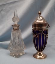 An Edward VII silver and blue glass sugar caster with a flame finial and pierced domed lid,