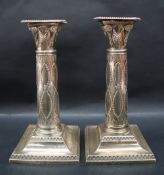 A pair of George V silver corinthian column candlesticks,