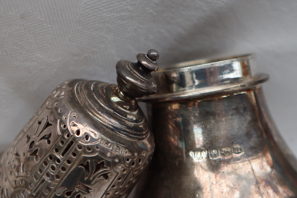 A George V silver sugar caster with a pierced domed cover and ring turned baluster body on a - Image 2 of 3