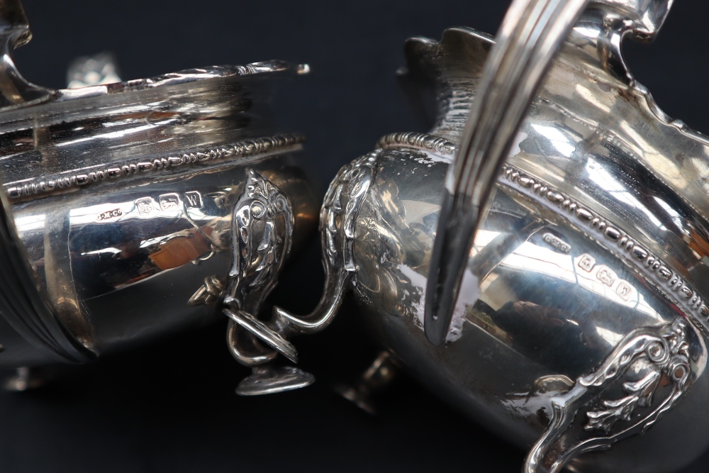 A George V silver cream jug and matching twin handled sugar basin, with a shaped leaf cast edge, - Image 4 of 4