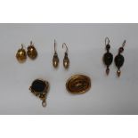 A pair of silver gilt acorn earrings together with a pair of yellow metal oval earrings,