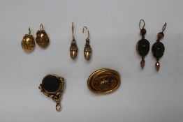 A pair of silver gilt acorn earrings together with a pair of yellow metal oval earrings,