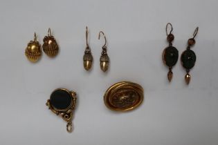 A pair of silver gilt acorn earrings together with a pair of yellow metal oval earrings,