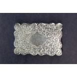 A late Victorian silver snuff box of shaped rectangular form with leaf decoration and a vacant