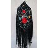 A silk piano shawl, the black ground profusely embroidered with peacocks,