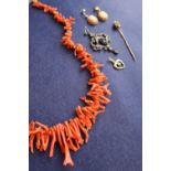 A coral necklace, comprising irregular shaped strands,