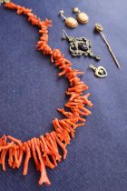 A coral necklace, comprising irregular shaped strands,
