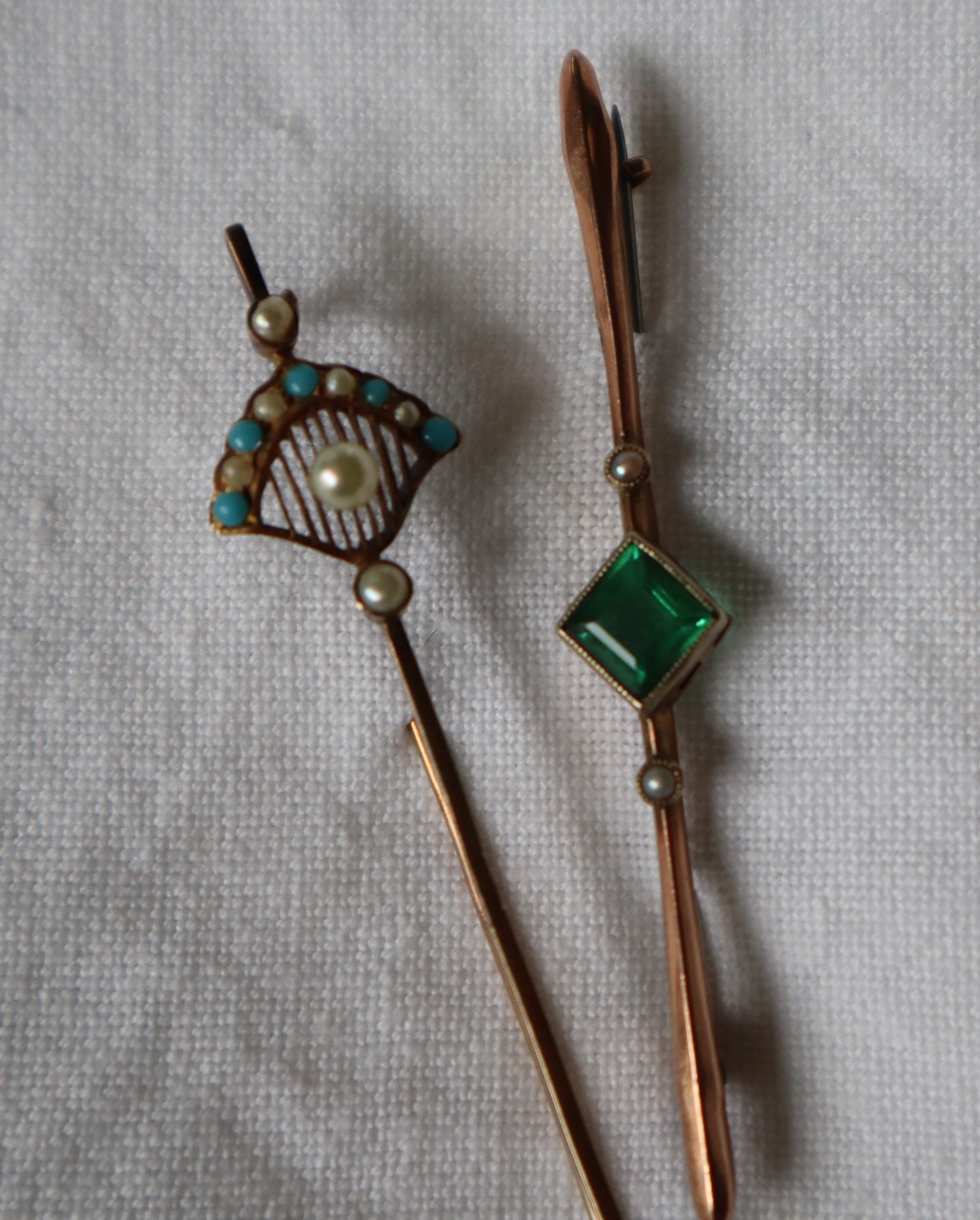 A yellow metal stock pin, of fan shape set with seed pearls and turquoise beads, the pin marked 14k,
