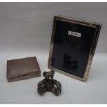 A silver cigarette box of rectangular form together with a silver photograph frame and a silver