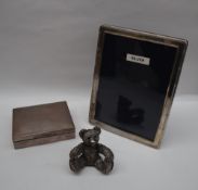 A silver cigarette box of rectangular form together with a silver photograph frame and a silver