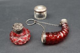A white metal mounted cornucopia shaped cranberry glass scent bottle,
