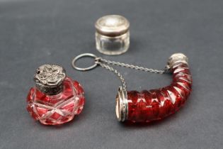 A white metal mounted cornucopia shaped cranberry glass scent bottle,