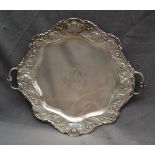 American Silver - A Sterling silver twin handled tray with a scrolling leaf and flowerhead border,