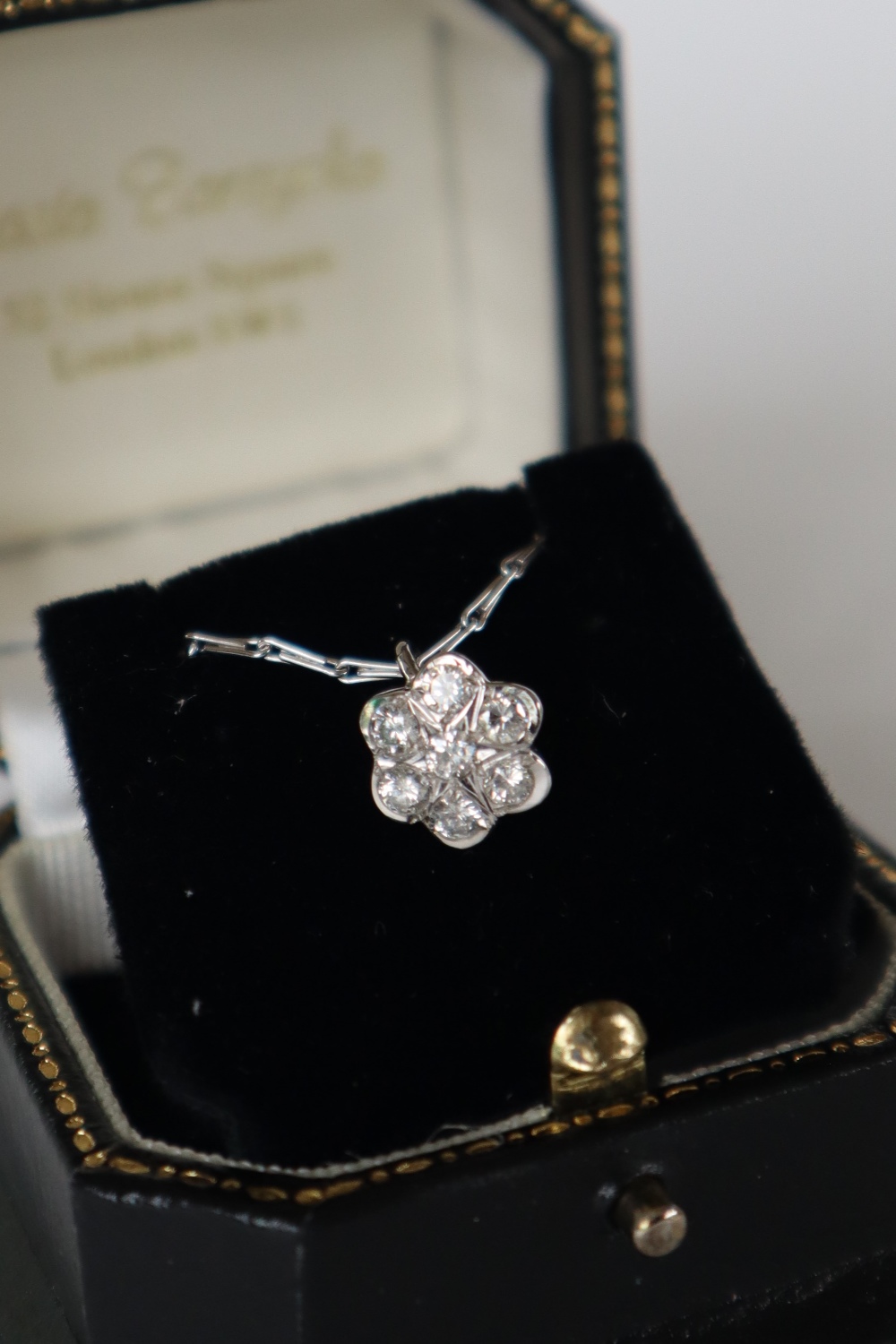 An 18ct white gold diamond set pendant of floral form set with seven round brilliant cut diamonds - Image 6 of 7