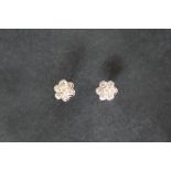 A pair of 18ct white gold diamond cluster earrings, set with seven round brilliant cut diamonds,