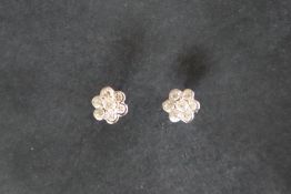 A pair of 18ct white gold diamond cluster earrings, set with seven round brilliant cut diamonds,