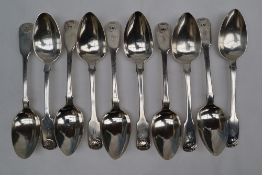 A set of eight George IV silver fiddle and shell pattern dessert spoons, London, 1824,