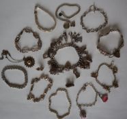 A silver charm bracelet, set with numerous charms including a church, bunch of keys, horse, bible,