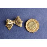 A Victorian 9ct gold brooch of circular form applied with flowers and leaves,