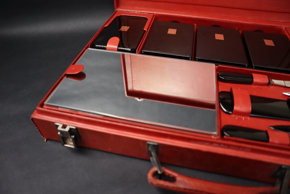 S T Dupont, a red leather travelling case fitted with two brushes, three bottles, easel mirror, - Image 2 of 20