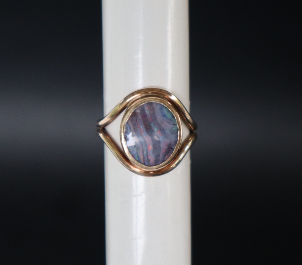 A 9ct gold ring, set with an oval opal panel, size M, approximately 5.