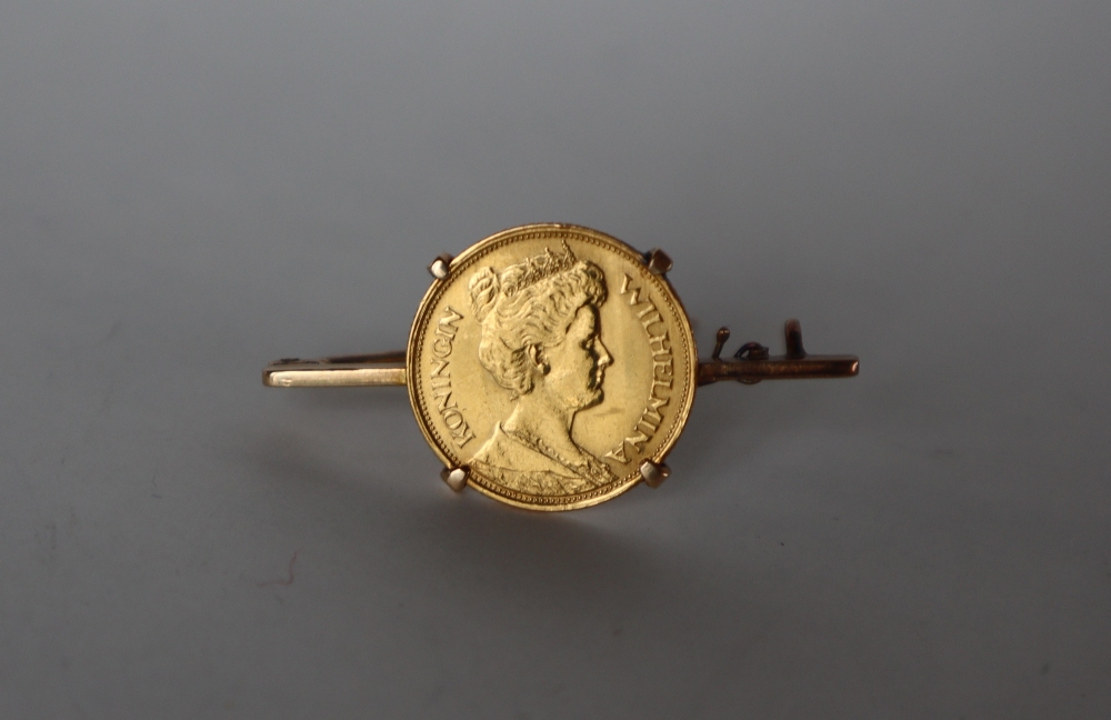 A 1912 5 Gulden Wilhelmina gold coin set into a yellow metal bar brooch, overall approximately 5.