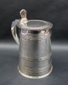 A George III silver lidded tankard with pierced fan thumb piece above a tapering line decorated