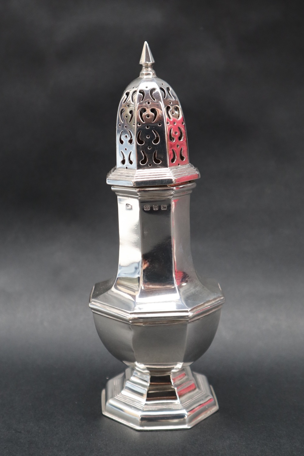 A late Victorian silver sugar caster with a pointed finial and pierced octagonal domed top on a - Image 3 of 4