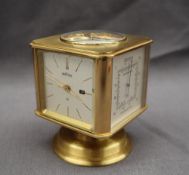 An Angelus brass cube form desk top clock / weather station, the top inset with a compass,