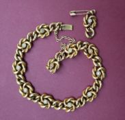 A yellow metal bracelet with oval and knotted links set with pearls, 19cm long approximately 14.