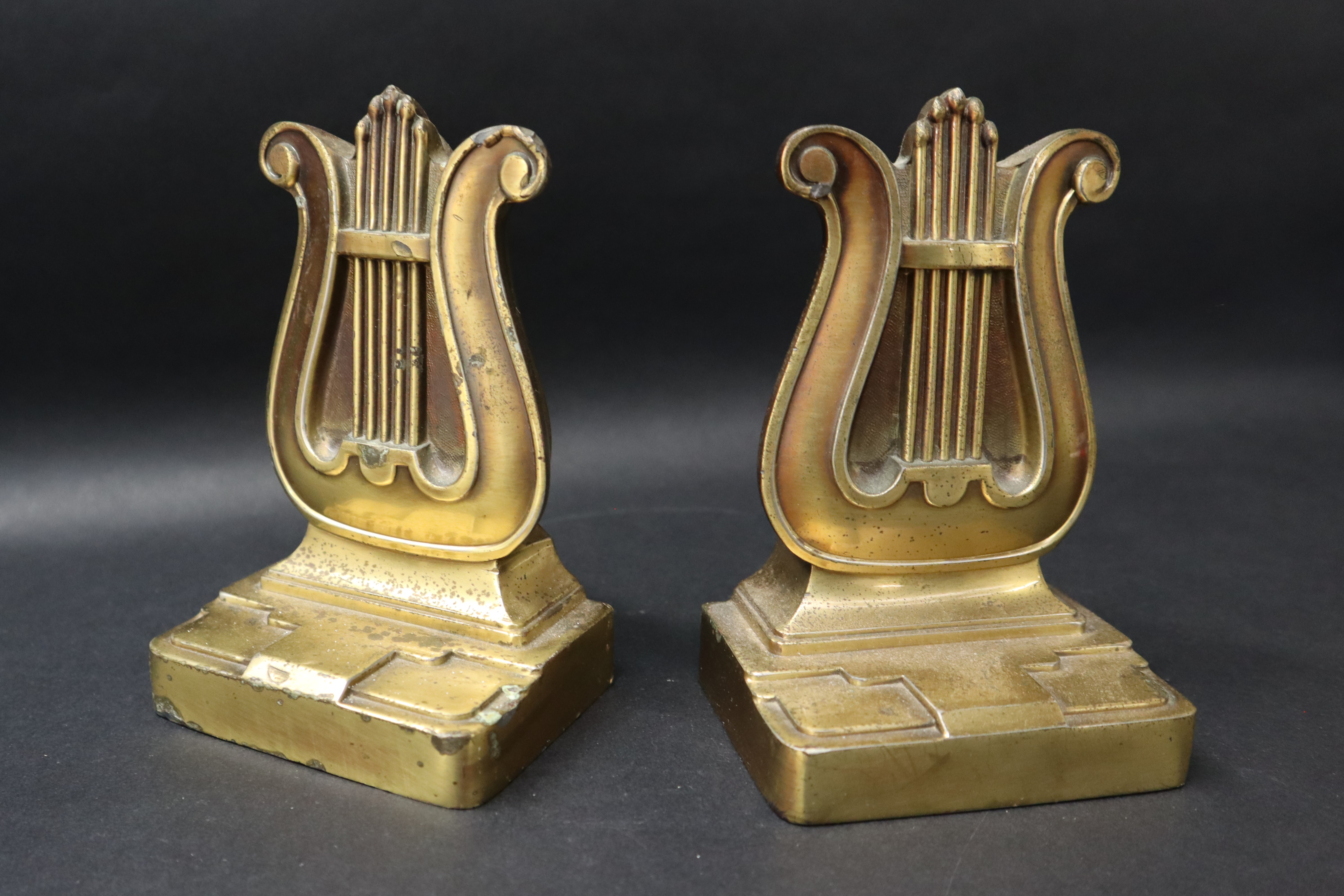 A pair of bronze book ends in the form of lyres on a rectangular base, moulded 56B PMC, - Image 2 of 6