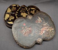 A Japanese black lacquer papier mache box and cover of lobed fall decorated with birds,