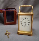 A 19th century French brass carriage timepiece with a rectangular enamel dial and Roman numerals,