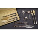A continental white metal part serving set, comprising salad servers with bakelite ends,
