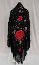 A silk piano shawl, the black ground profusely embroidered with red roses,