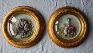 A pair of porcelain figural panels depicting two of the seasons,
