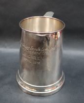 An Elizabeth II silver tankard of tapering cylindrical form, with a scrolling handle,
