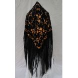 A silk piano shawl, the black ground decorated with embroidered gold roses and other flowers,
